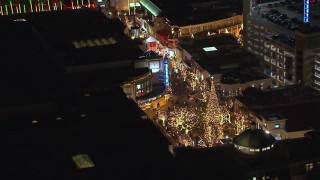 CAP_018_149 - HD stock footage aerial video of an orbit around a Christmas tree at The Grove shopping mall at night in Los Angeles, California