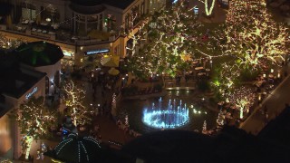 CAP_018_150 - HD stock footage aerial video of an orbit around a fountain at The Grove shopping mall at night in Los Angeles, California
