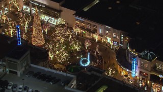 CAP_018_151 - HD stock footage aerial video of circling a fountain at The Grove shopping mall at night in Los Angeles, California