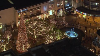 CAP_018_152 - HD stock footage aerial video of orbiting a fountain at The Grove shopping mall at night in Los Angeles, California