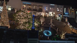 CAP_018_155 - HD stock footage aerial video of orbiting The Grove shopping mall fountain, decorated for the holidays, at night in Los Angeles, California