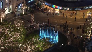 CAP_018_156 - HD stock footage aerial video of orbiting fountain at The Grove shopping mall, decorated for the holidays at night in Los Angeles, California