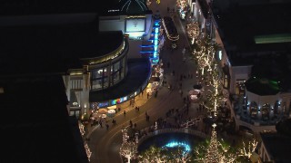 CAP_018_157 - HD stock footage aerial video of the fountain at The Grove shopping mall, decorated for the holidays at night in Los Angeles, California