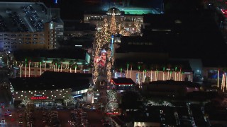 CAP_018_159 - HD stock footage aerial video approach The Grove shopping mall, decorated for the holidays at night in Los Angeles, California