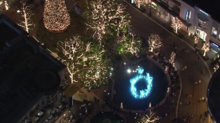 CAP_018_162 - HD stock footage aerial video of Christmas decorations and fountain at The Grove shopping mall at night in Los Angeles, California