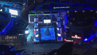 CAP_018_193 - HD stock footage aerial video zoom to wider view of an ice skating rink and Christmas tree at night, Downtown Los Angeles, California