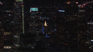 CAP_018_213 - HD stock footage aerial video of zoom from rooftop Christmas tree to reveal skyscrapers, Downtown Los Angeles, California