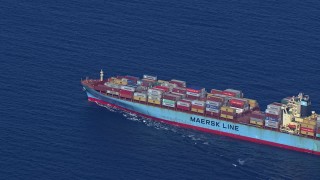 CAP_020_020 - HD stock footage aerial video zoom out while tracking a cargo ship near Miami Beach, Florida