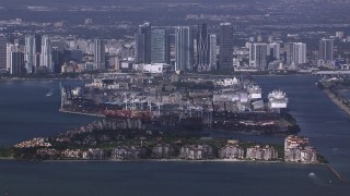 CAP_020_025 - HD stock footage aerial video of the port behind Fisher Island, downtown skyline in background, Miami, Florida