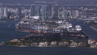 CAP_020_026 - HD stock footage aerial video of passing Fisher Island, Port of Miami and downtown skyline, Florida