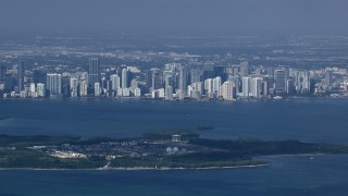 CAP_020_029 - HD stock footage aerial video zoom to a closer view of the Downtown Miami skyline across Biscayne Bay, Florida