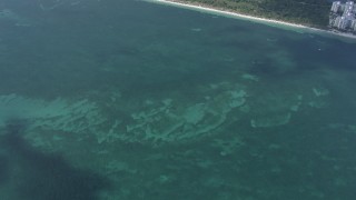 CAP_020_032 - HD stock footage aerial video of a bird's eye view of the Atlantic Ocean, reveal shore of Key Biscayne near Miami, Florida