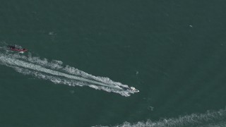 CAP_020_035 - HD stock footage aerial video of a bird's eye view of a boat racing across the water near Miami, Florida