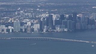 CAP_020_044 - HD stock footage aerial video of flying by the city's skyline behind the Rickenbacker Causeway, Miami, Florida