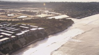 CAP_021_009 - HD stock footage aerial video fly away from coastal cliffs, neighborhoods and apartment buildings, Del Mar, California