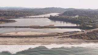 CAP_021_012 - HD stock footage aerial video passing by a lagoon and coastal highway by a beach, Encinitas, California