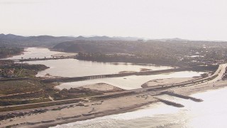 CAP_021_013 - HD stock footage aerial video of a lagoon and coastal highway by a beach, Encinitas, California