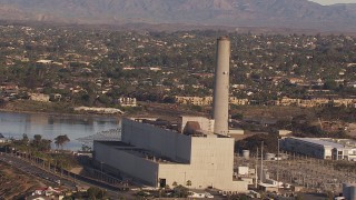 CAP_021_016 - HD stock footage aerial video of orbiting the power plant smoke stack in Carlsbad, California
