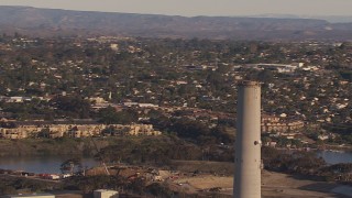CAP_021_017 - HD stock footage aerial video of circling the power plant smoke stack in Carlsbad, California