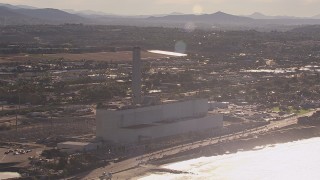 CAP_021_018 - HD stock footage aerial video of flying away from the power plant and smoke stack in Carlsbad, California