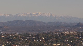 CAP_021_020 - HD stock footage aerial video of distant snow mountains seen from hillside homes, Carlsbad, California