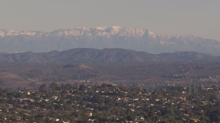 CAP_021_021 - HD stock footage aerial video of snow mountains in the distance, seen from hillside homes, Carlsbad, California