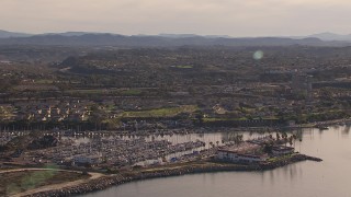 CAP_021_027 - HD stock footage aerial video of a marina and oceanfront hotel by coastal neighborhood, Oceanside, California