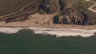 CAP_021_037 - HD stock footage aerial video of flying by an empty strip of beach on the coast, Oceanside, California