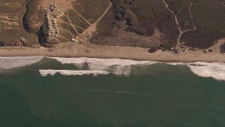 CAP_021_038 - HD stock footage aerial video of passing by an empty strip of beach on the coast, Oceanside, California