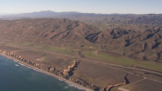CAP_021_041 - HD stock footage aerial video of I-5 between mountains and coastal cliffs, San Clemente, California