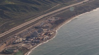 CAP_021_051 - HD stock footage aerial video of a reverse view of the San Onofre Nuclear Power Plant on the coast, California