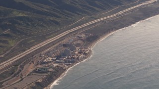 CAP_021_052 - HD stock footage aerial video of flying away from the San Onofre Nuclear Power Plant on the coast, California