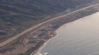 CAP_021_053 - HD stock footage aerial video of flying away from the San Onofre Nuclear Power Plant beside the ocean, California