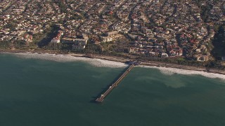 CAP_021_056 - HD stock footage aerial video of orbiting a pier by coastal neighborhoods in San Clemente, California