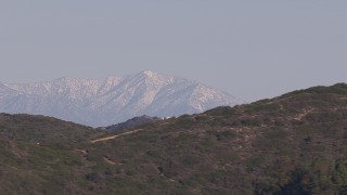 CAP_021_066 - HD stock footage aerial video of a wide view of distant snowy mountains in Dana Point, California