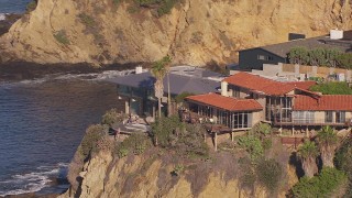 CAP_021_072 - HD stock footage aerial video of orbiting clifftop mansions overlooking the ocean, Laguna Beach, California