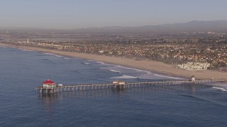 CAP_021_081 - HD stock footage aerial video of flying toward a diner on a pier, Huntington Beach, California