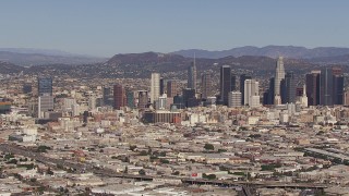 CAP_021_089 - HD stock footage aerial video of approaching the city's skyline and Hollywood Sign, Downtown Los Angeles, California
