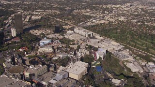 CAP_021_122 - HD stock footage aerial video tilt to and orbit Universal Studios Hollywood, Universal City, California