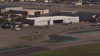 CAP_021_132 - HD stock footage aerial video of civilian jets and helicopters at a Burbank Airport hangar, California