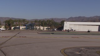 CAP_021_135 - HD stock footage aerial video approach civilian jets by aviation building at Burbank Airport, California