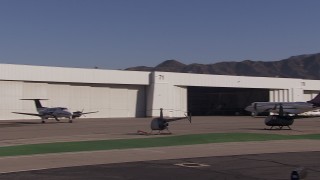 CAP_021_136 - HD stock footage aerial video of passing civilian jets and helicopters by a Burbank Airport hangar, California