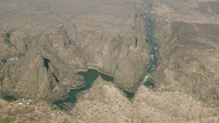 CAP_026_003 - HD stock footage aerial video of orbiting a deep canyon and river near Victoria Falls, Zimbabwe