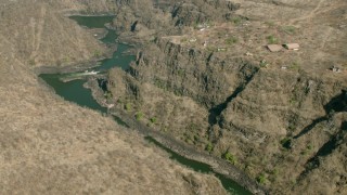 CAP_026_004 - HD stock footage aerial video of flying away from a deep canyon and river near Victoria Falls, Zimbabwe