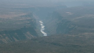 CAP_026_005 - HD stock footage aerial video of flying by a river in a deep canyon near Victoria Falls, Zimbabwe