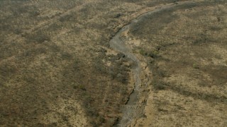 CAP_026_022 - HD stock footage aerial video of tilting to a dry riverbed in the savanna, Zimbabwe