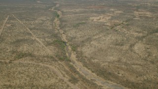 CAP_026_024 - HD stock footage aerial video of orbiting a dry riverbed in the savanna, Zimbabwe