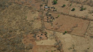 CAP_026_026 - HD stock footage aerial video of flying away from a small village in the savanna, Zimbabwe