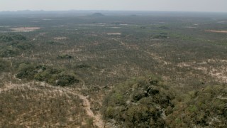 CAP_026_063 - HD stock footage aerial video of flying over hills and fields toward savanna, Zimbabwe