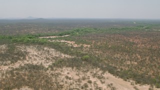CAP_026_079 - HD stock footage aerial video of a dry riverbed and trees in savanna, Zimbabwe